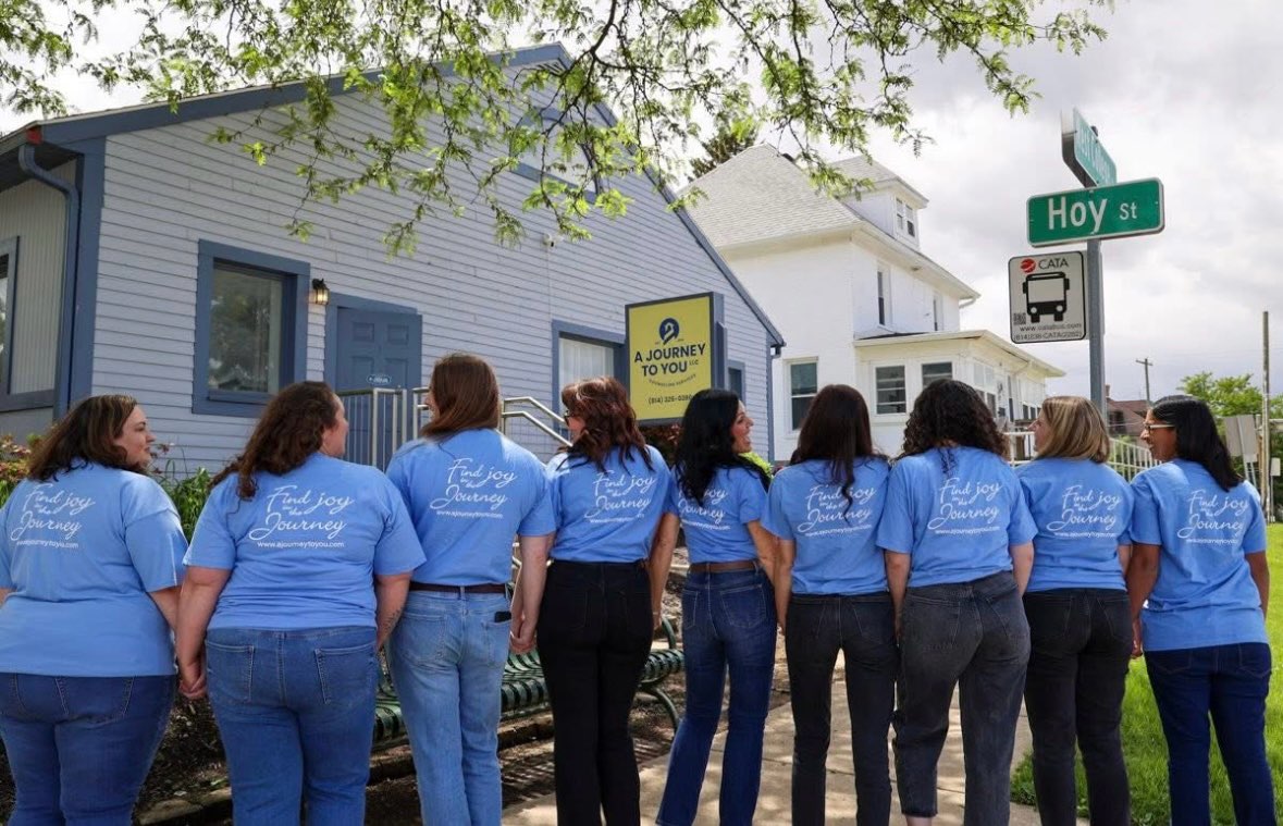A Journey To You Team wearing matching company shirts